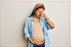 Pregnant women rubbing her eyes