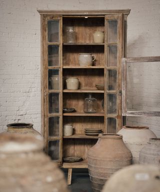 Wooden cabinet, glass windows, pots