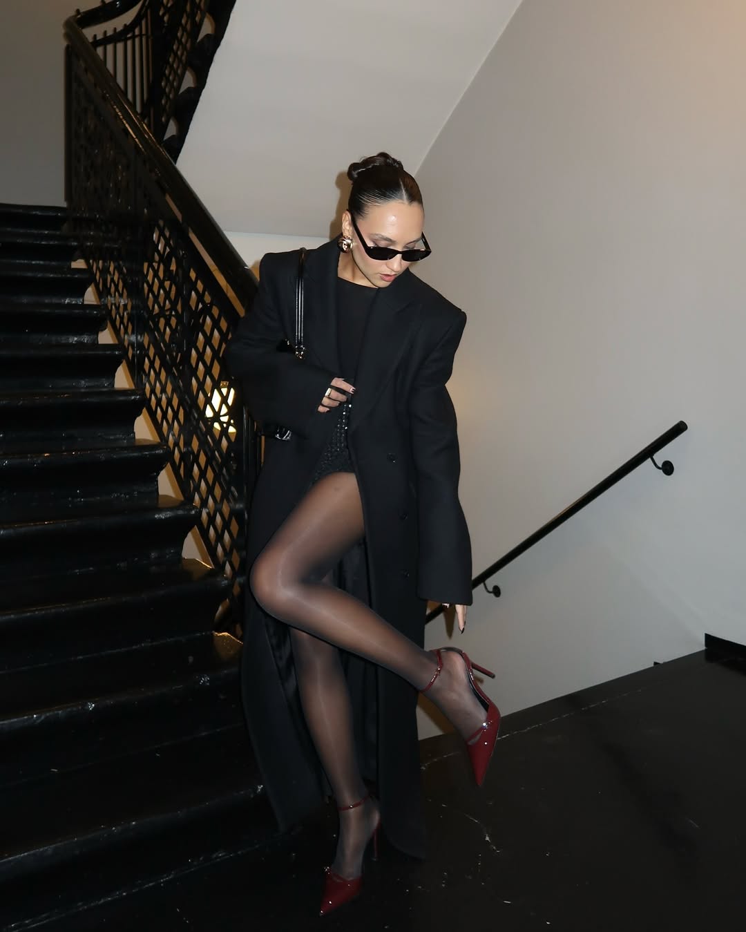 Ingrid in black wool coat and red high heels