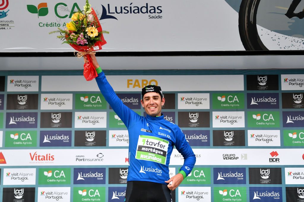 FARO PORTUGAL FEBRUARY 18 Joo Carlos Arajo Matias of Portugal and Team TavferMortguaOvos Matinados celebrates winning the blue mountain jersey on the podium ceremony after the 48th Volta Ao Algarve 2022 Stage 3 a 2114km stage from Almodvar to Faro VAlgarve2022 on February 18 2022 in Faro Portugal Photo by Luc ClaessenGetty Images