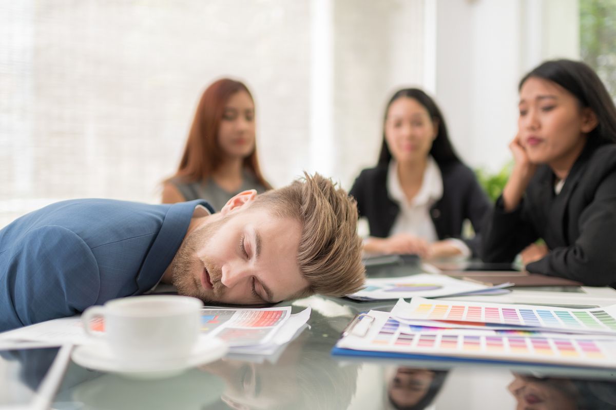 Business people sleeping in the conference room during a meeting.