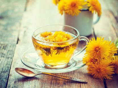 Yellow Dandelion Herbal Tea On Wooden Table