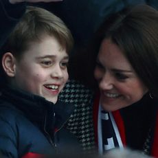 Britain's Prince George of Cambridge (L) talks to his mother Britain's Catherine, Duchess of Cambridge as they attend the Six Nations international rugby union match between England and Wales at Twickenham Stadium, west London
