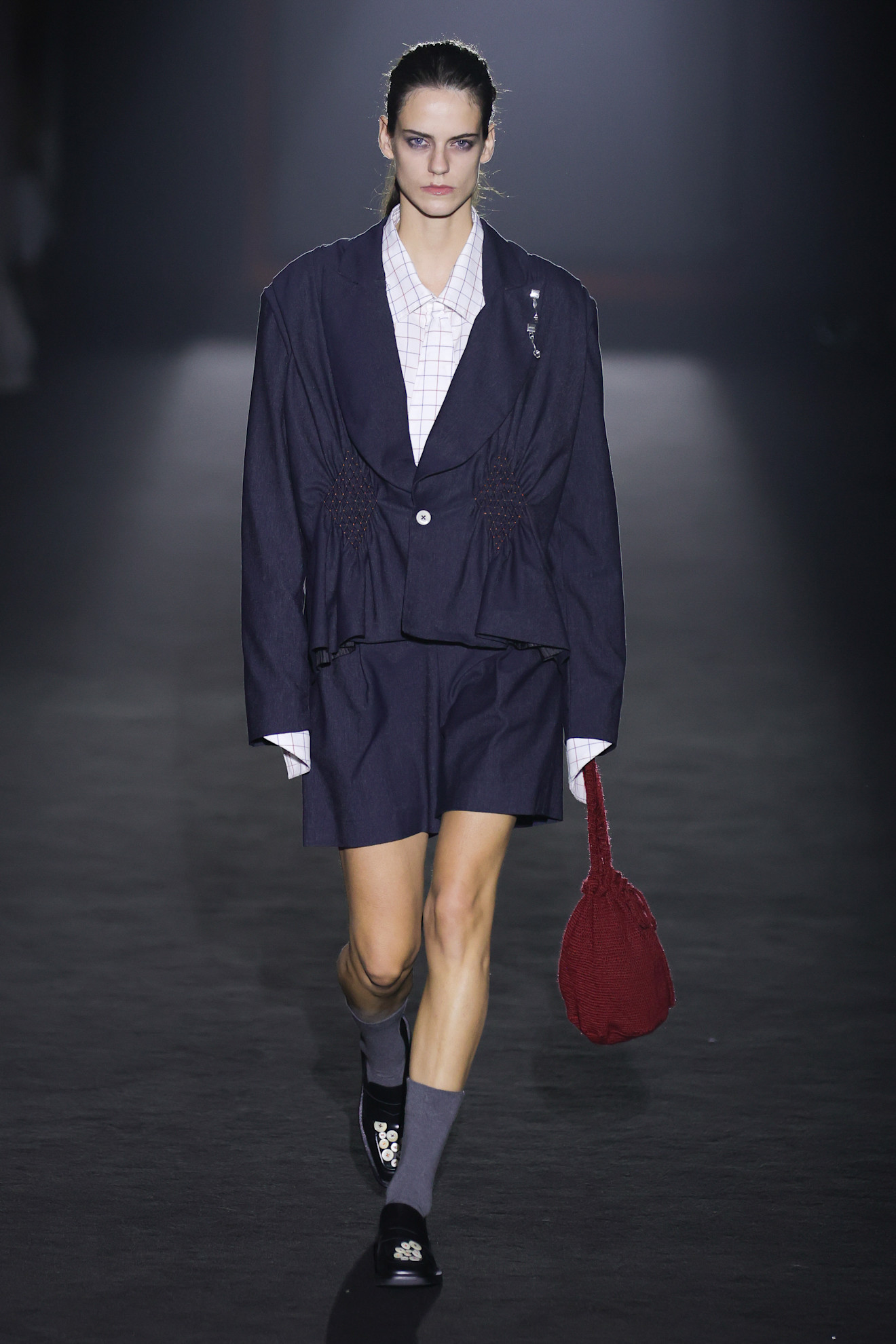 A model wore the navy and burgundy color combination on the Lemachet Spring 2026 runway