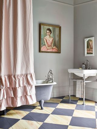 A bathroom with painted wooden floorboards