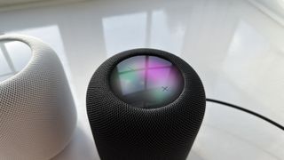 Apple HomePod 2 on a white surface with its top panel visible