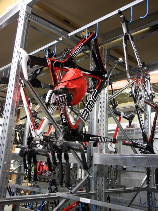 Unneeded time trial bikes are racked up along with the rider's helmet - where one goes, so does the other.