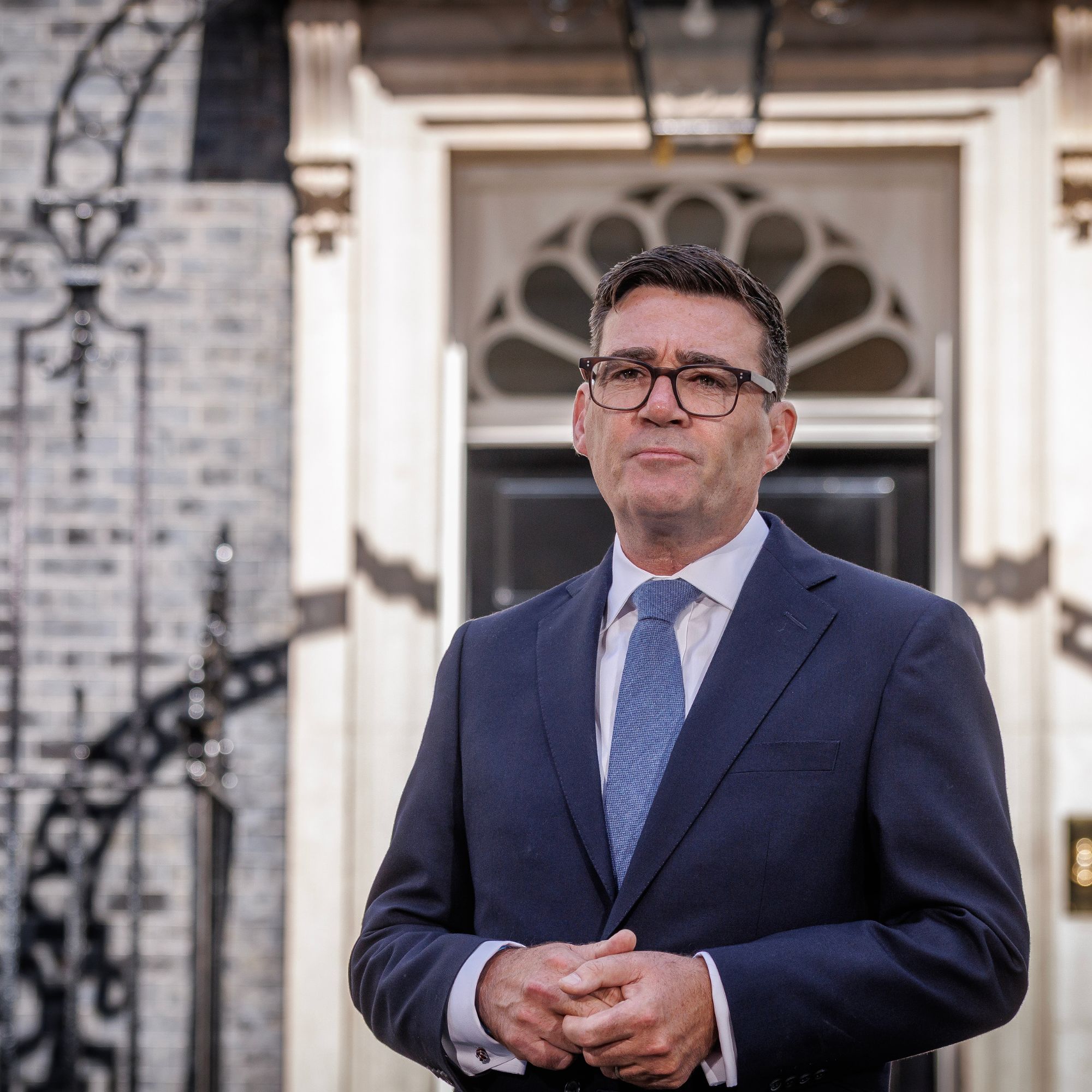 Prime Minister Andy Burnham wearing a suit giving a speech outside 10 Downing Street