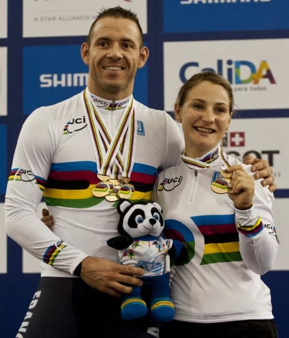 Francois Pervis (L) and Kristina Vogel pose on the podium with their medals won during at the UCI Track Cycling World Championships