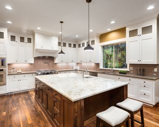 A classic kitchen with wood and granite island