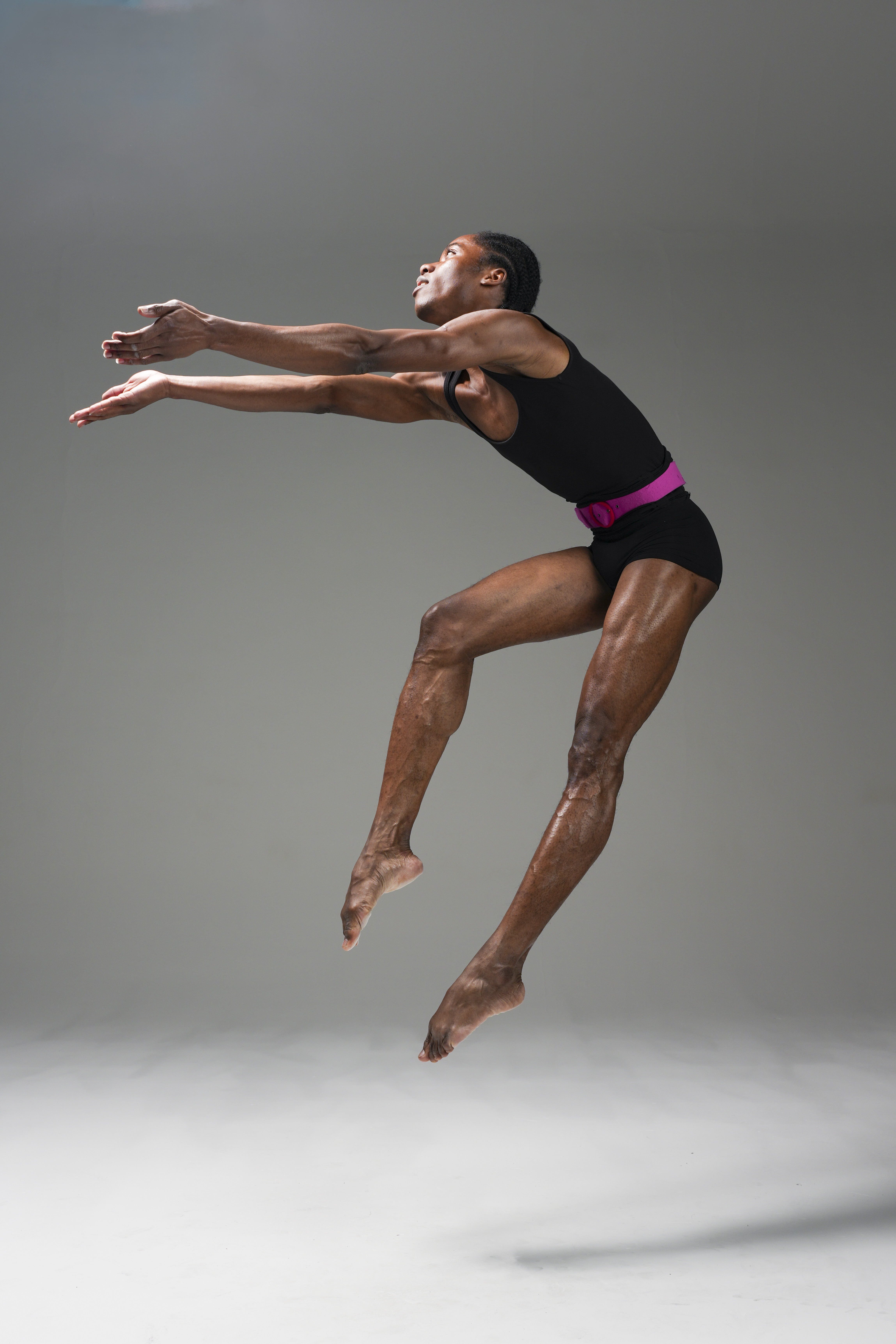 Dancer mid air in a white studio