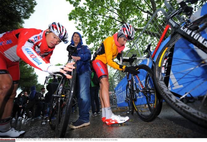 Katusha riders check their bikes after the mass crash on stage 6