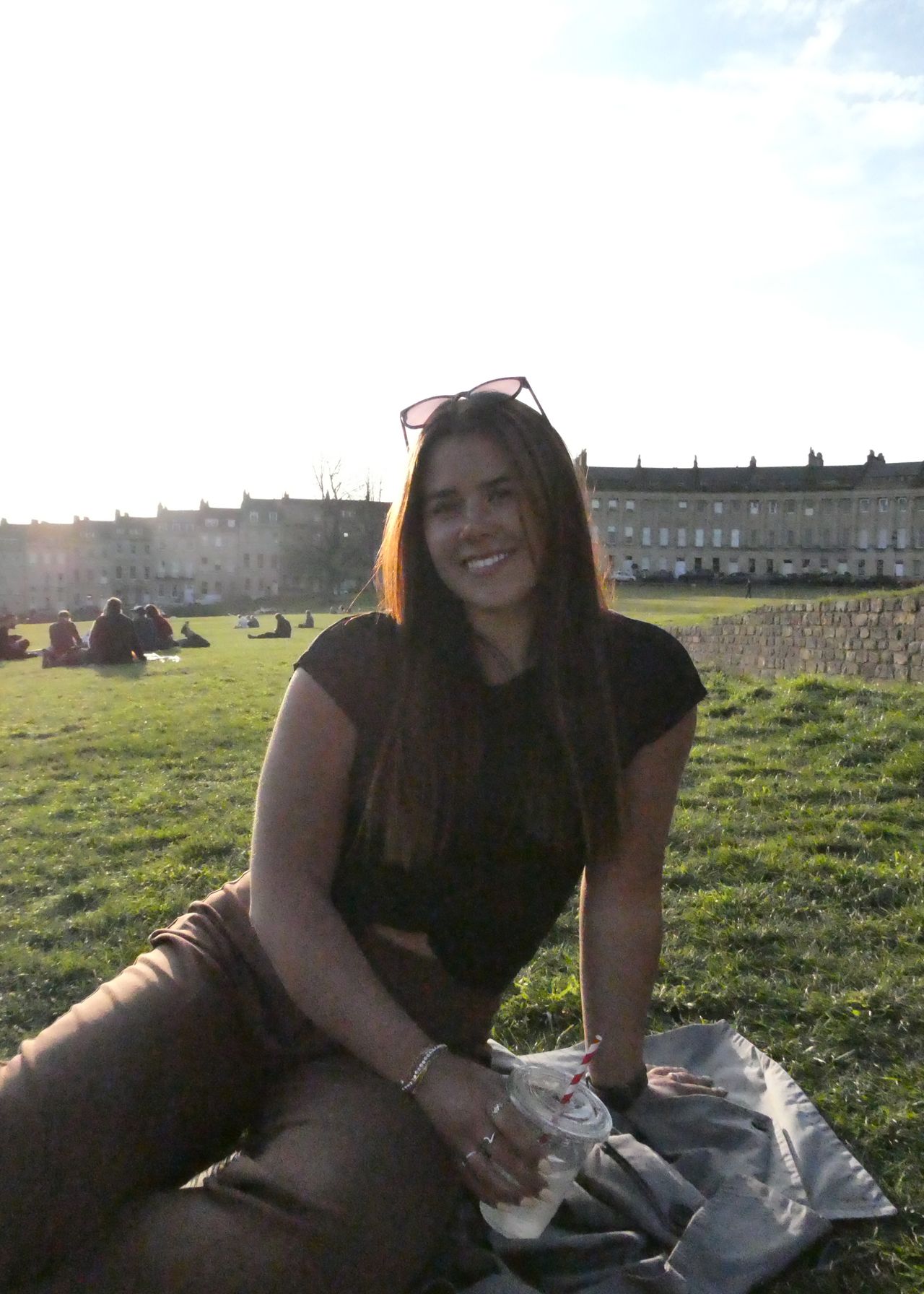Image of girl sat in park demonstrating the dynamic range of the Panasonic Lumix ZS99/TZ99.