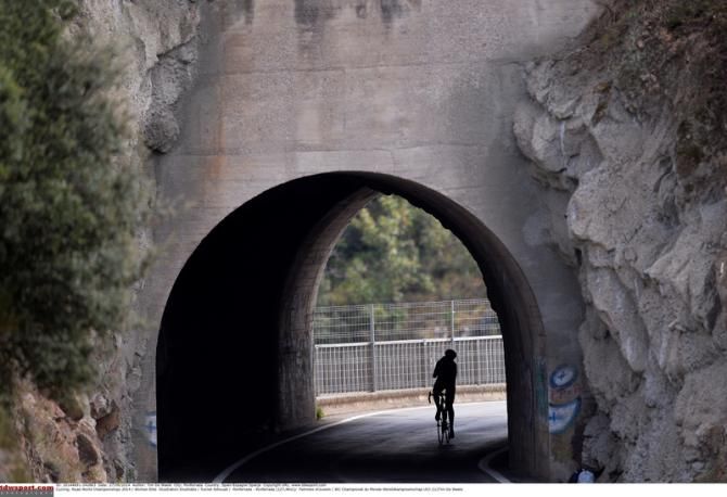 A lone rider comes through a tunnel on the course