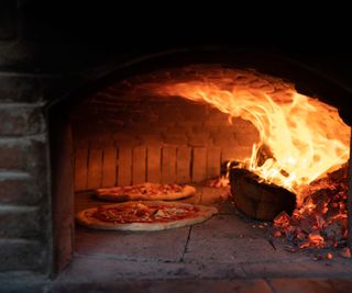 Cooking two pizzas in a brick oven