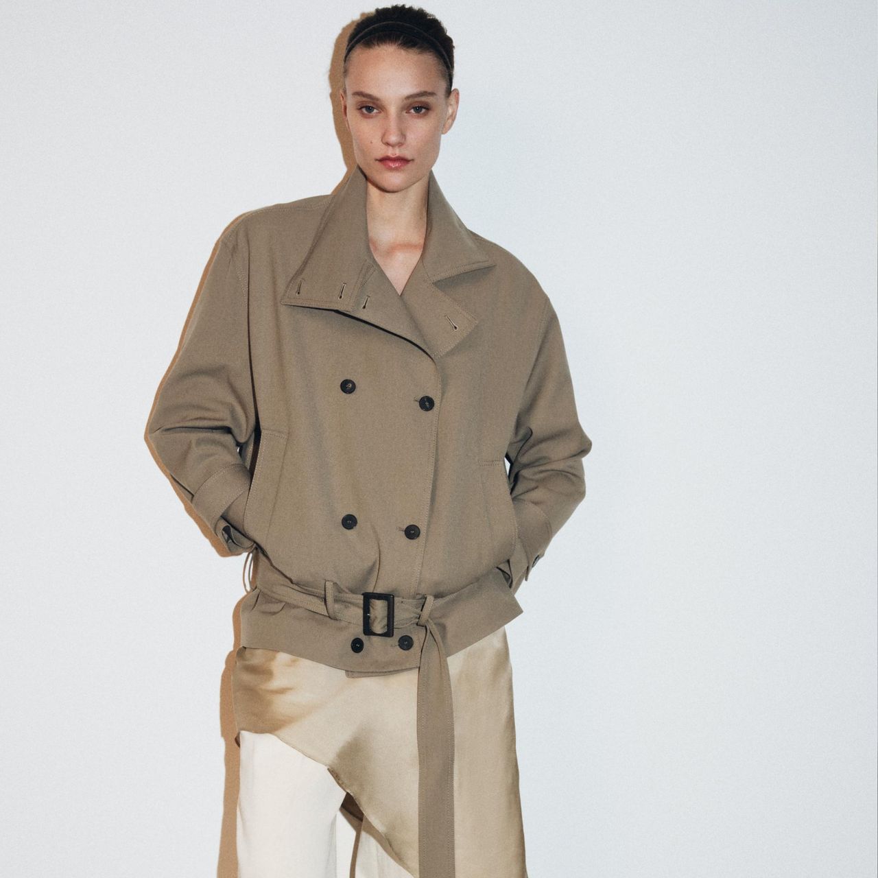 A model wearing a trench coat from Zara.