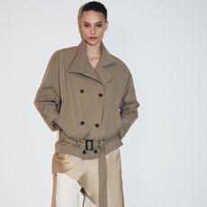 A model wearing a trench coat from Zara.