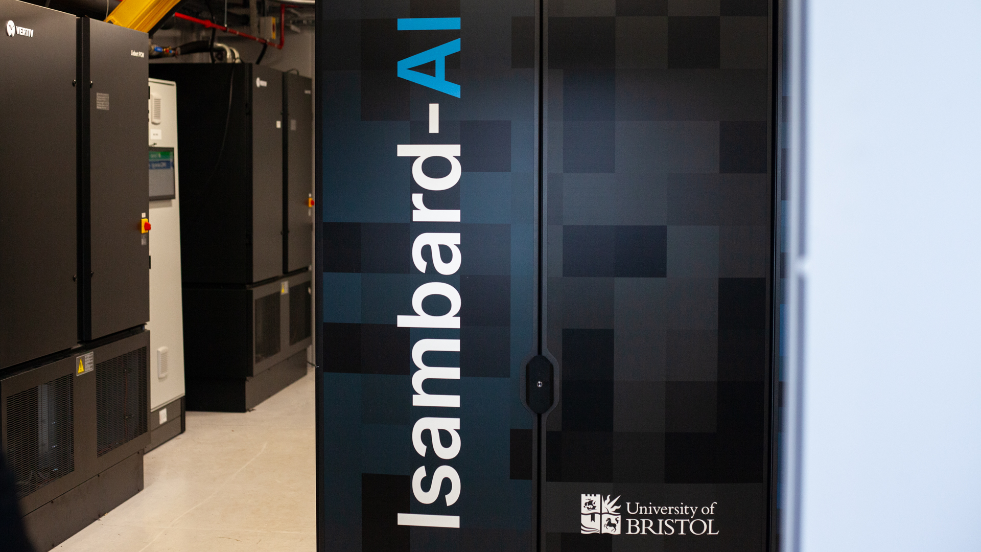 The Isambard-AI supercomputer, with the words "Isambard-AI" and the University of Bristol logo on the side of the server cabinet.