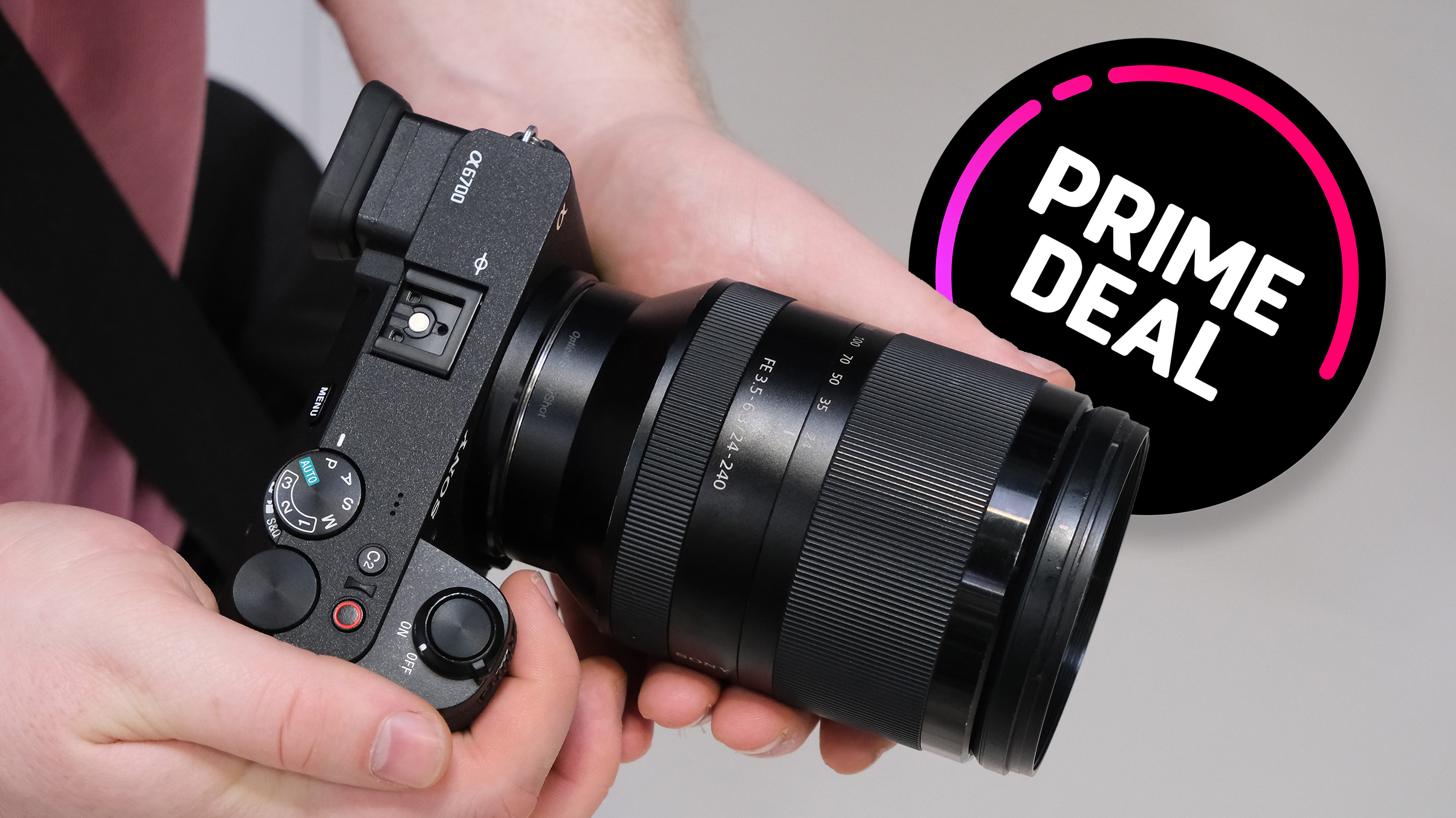 A person holds a Sony camera with a large lens, featuring a graphic overlay promoting a "Prime Deal"