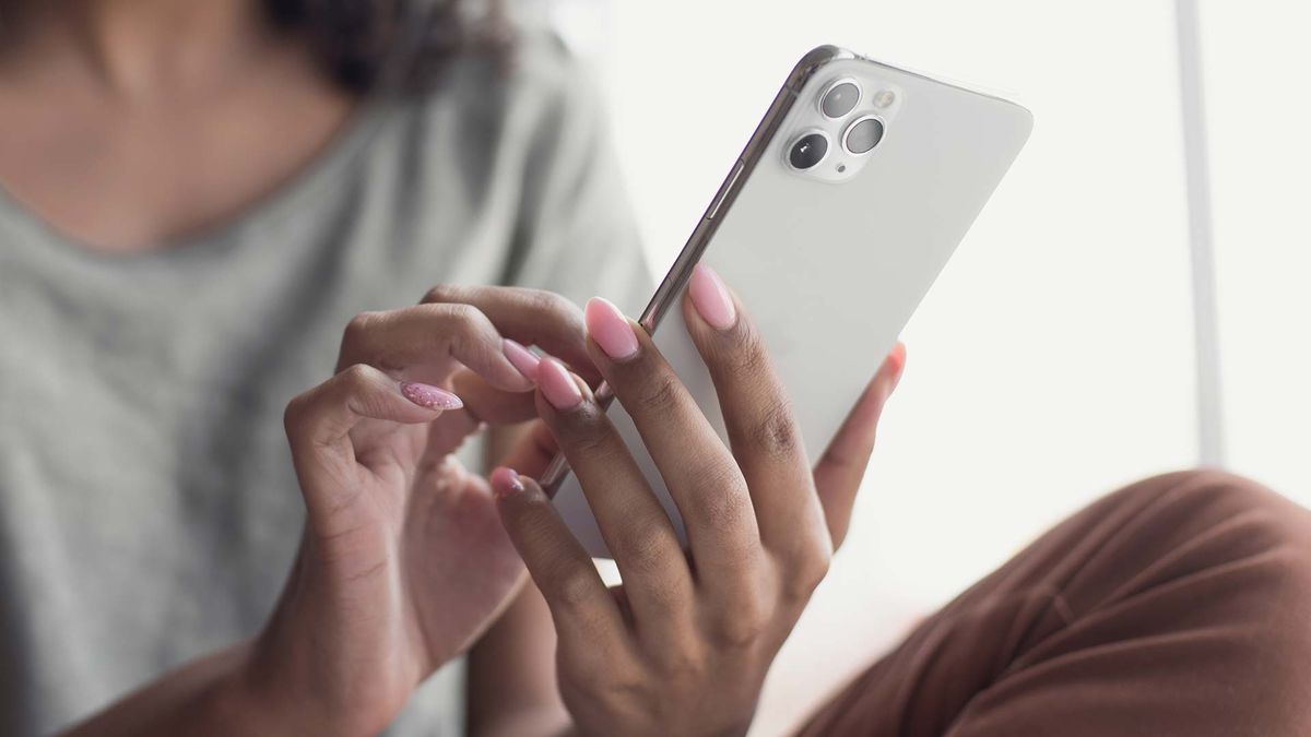 A woman typing on an iPhone