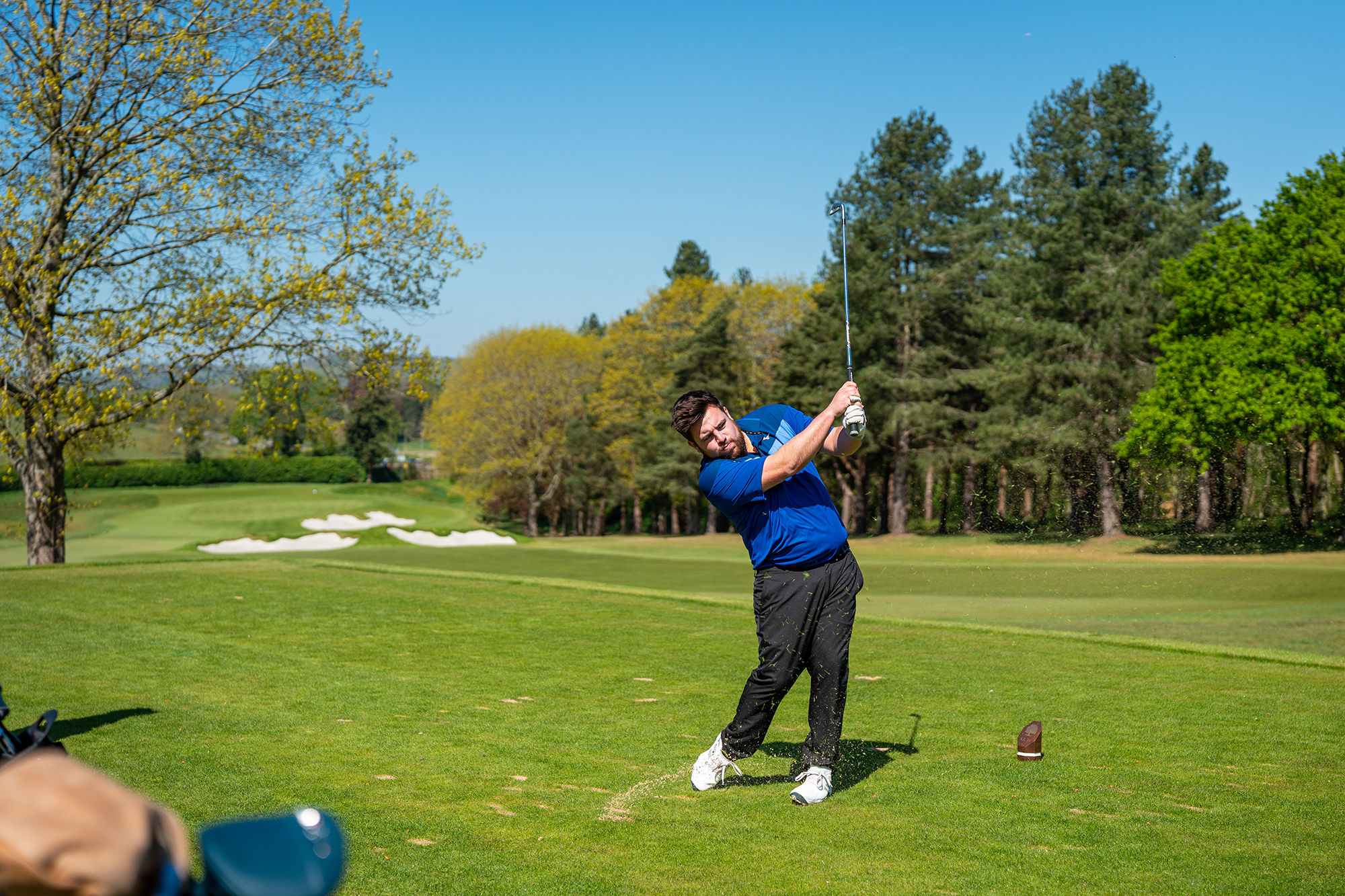 Matt Cradock hitting a 7-iron off the tee at Tandridge Golf Club