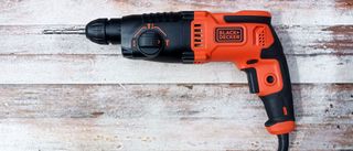 Black and Decker BEHS01 SDS Hammer Drill on worn, painted white wooden background