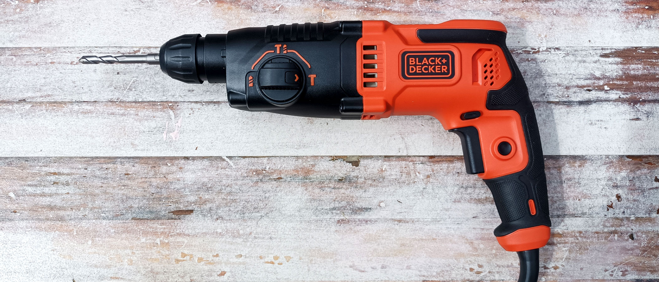 Black and Decker BEHS01 SDS Hammer Drill on worn, painted white wooden background