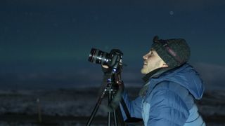 The author waiting for the aurora to appear with his camera set up and ready