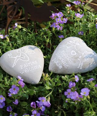 engraved pebbles in a fairy garden