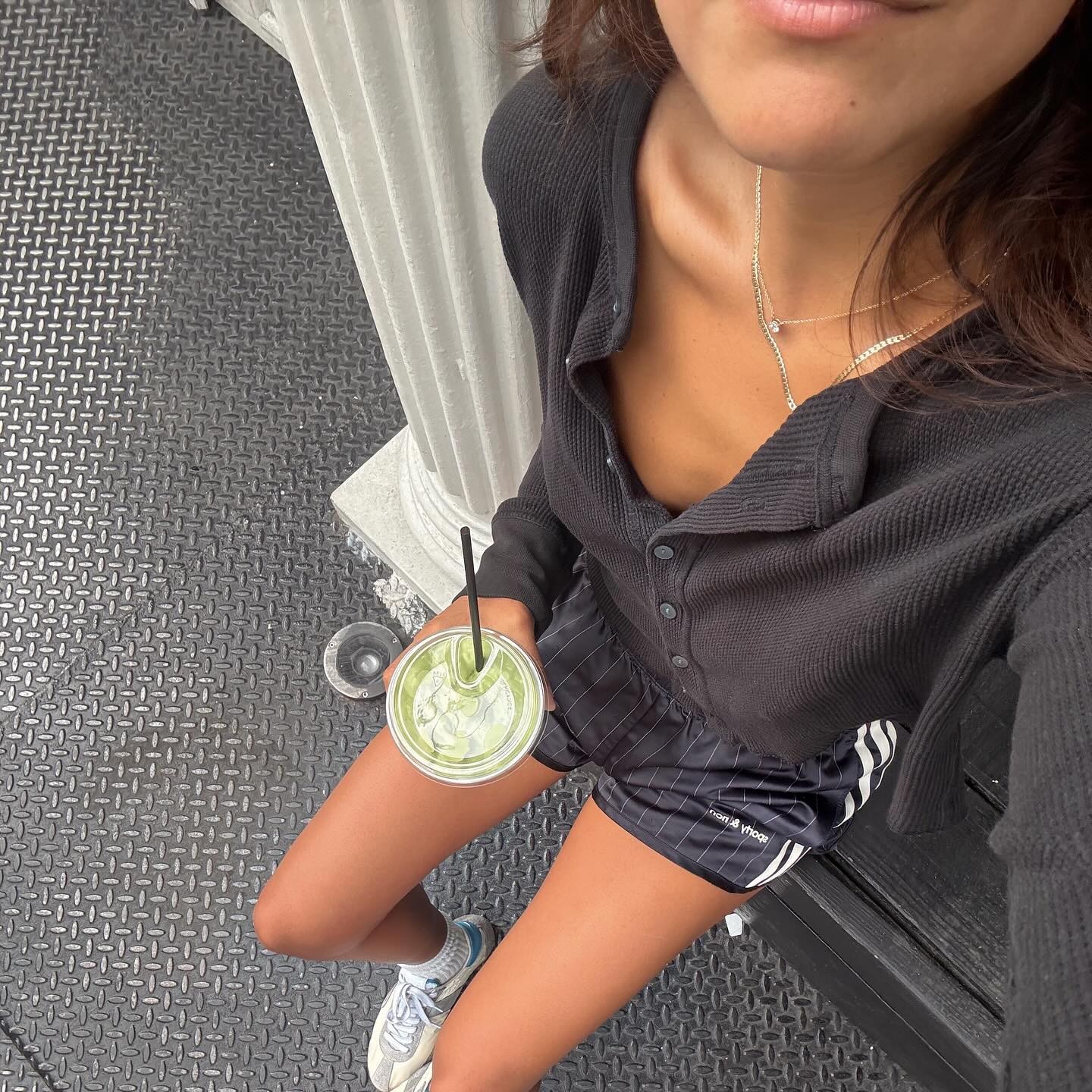 Photo of a woman wearing workout clothes sitting on steps outside