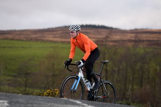 Image shows a person cycling outside in the winter