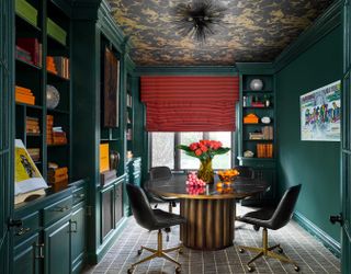 a green home office with orange accents