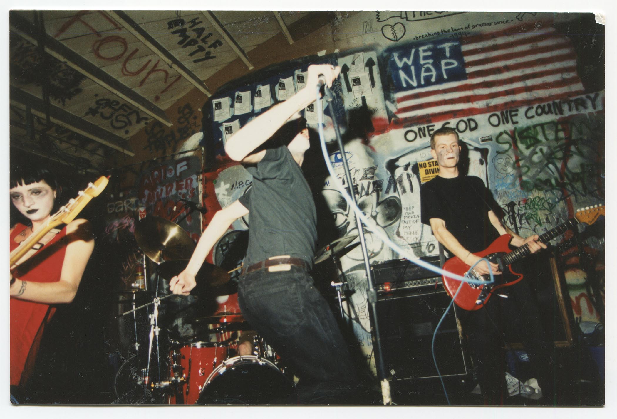 Ink &amp;amp; Dagger perform in makeup in a suitably punk looking venue with spray-painted walls.