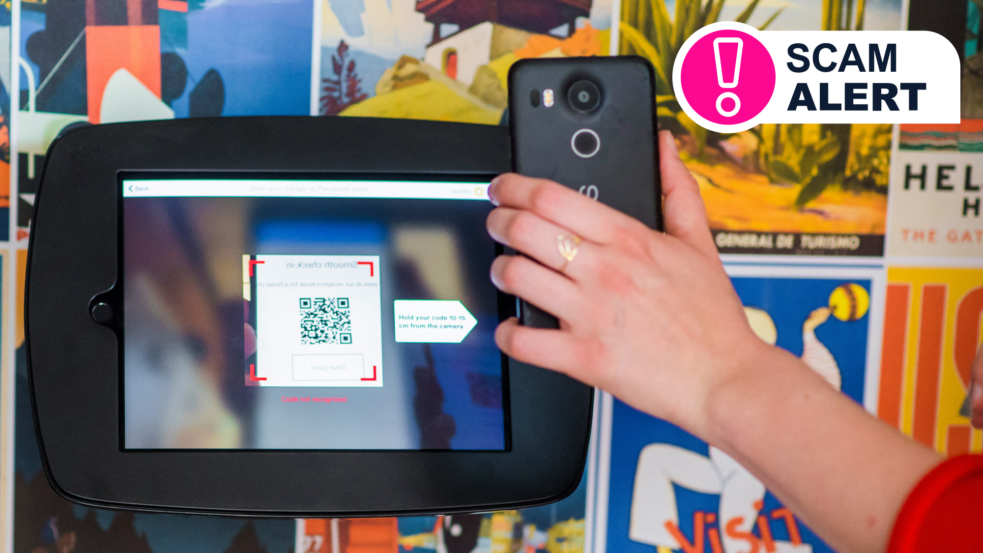 A hand holding a phone that&#039;s scanning a QR code on a screen