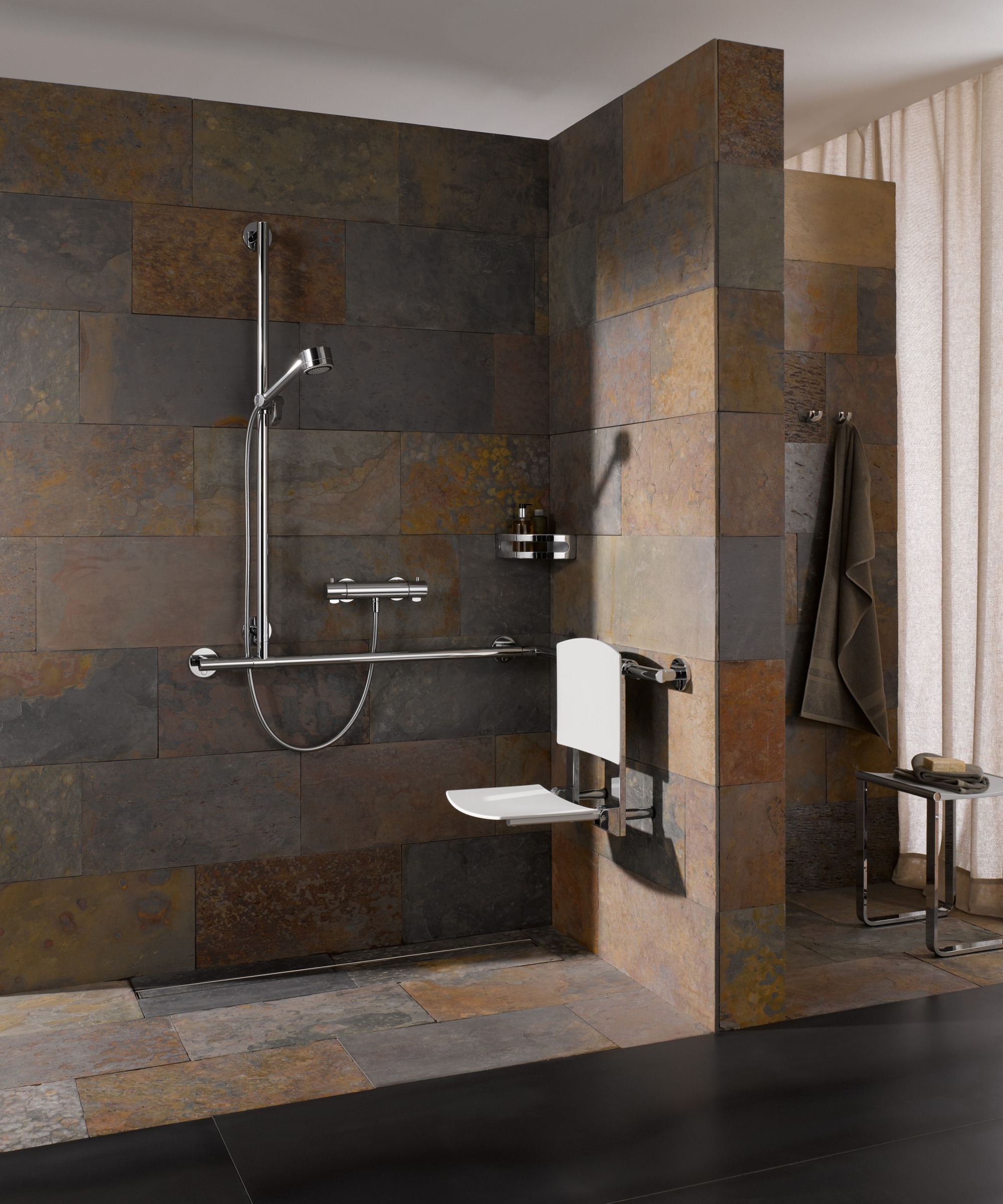 walk in wet room shower with accessible features including rails and shower seat