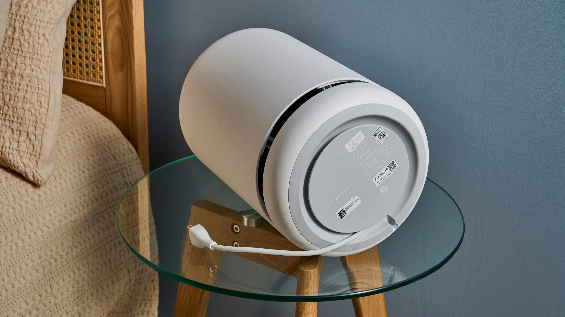 Picture shows the base and cable spool of a Molekule Air Mini Plus air purifier.