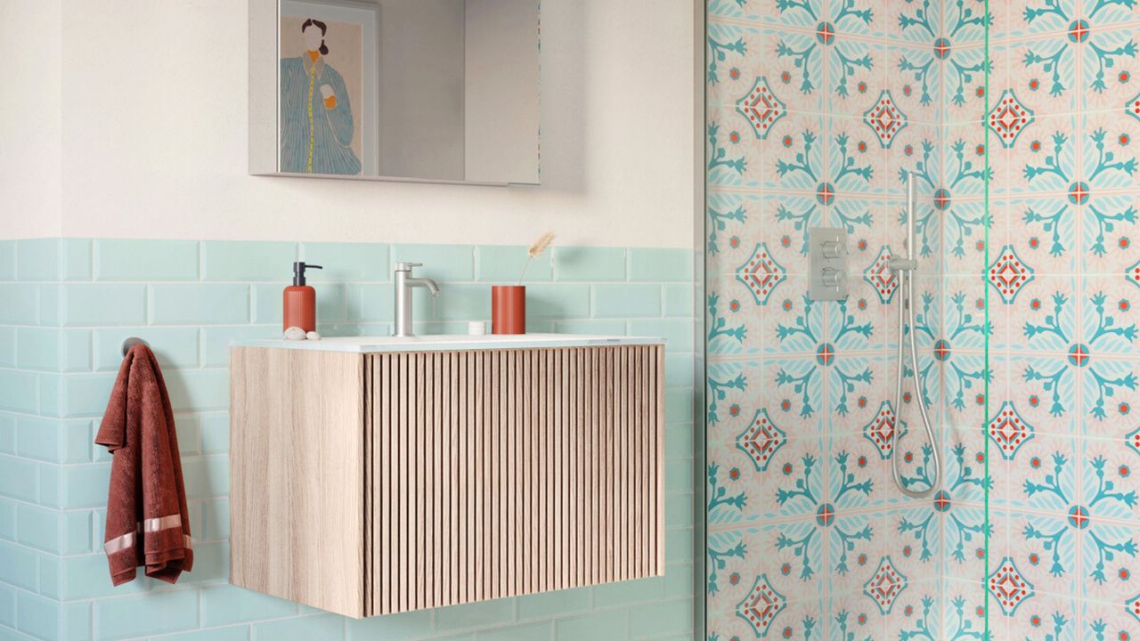 Small bathroom sink ideas are so chic. Here is a small bathroom with a light wooden floating vanity with a silver faucet, light blue splashback tiles, a white wall with a silver cabinet above it