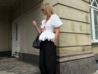 Woman wearing a white top and black skirt