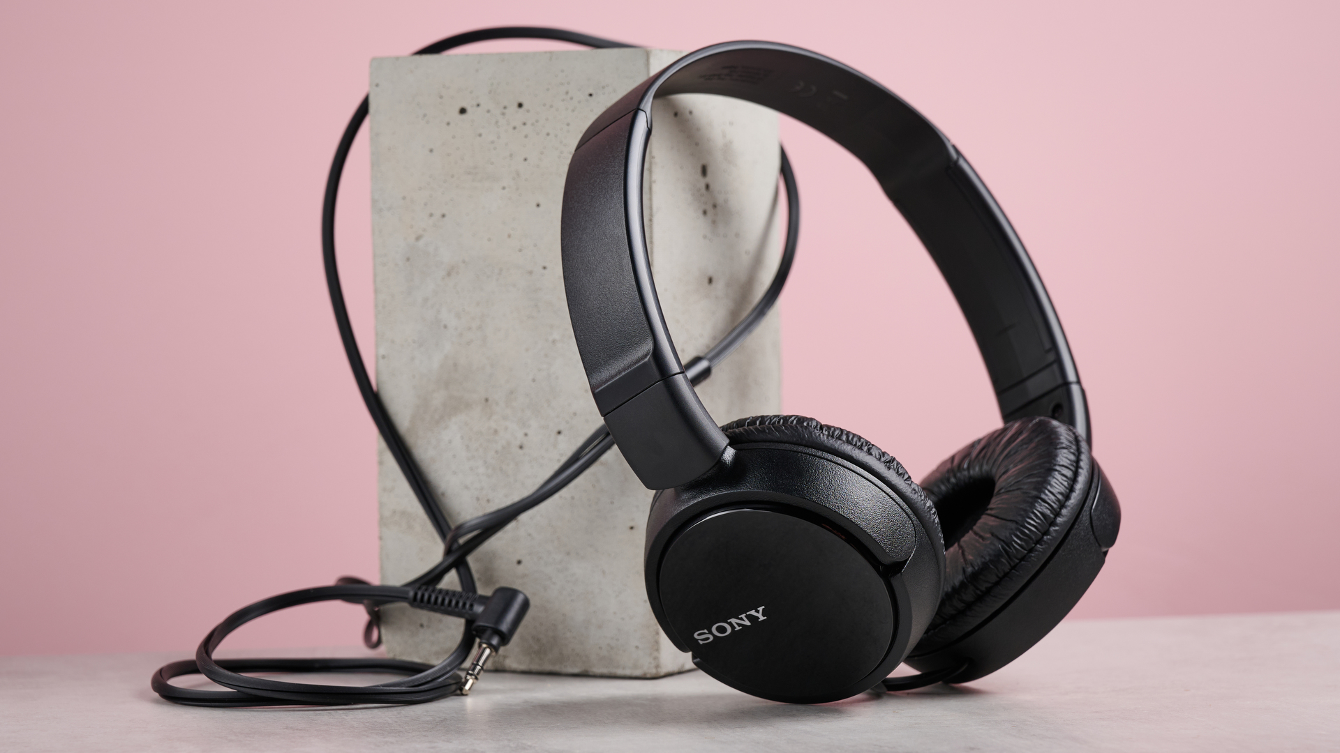 The Sony MDR-ZX110 leaning at a 45-degree angle against a pillar.
