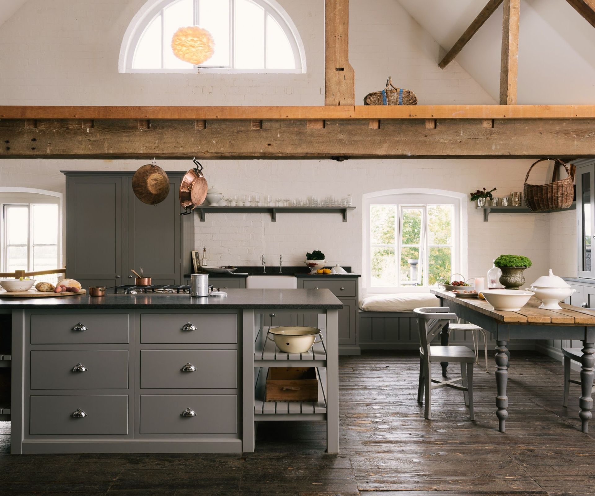 An open plan kitchen with a large island and a dining table