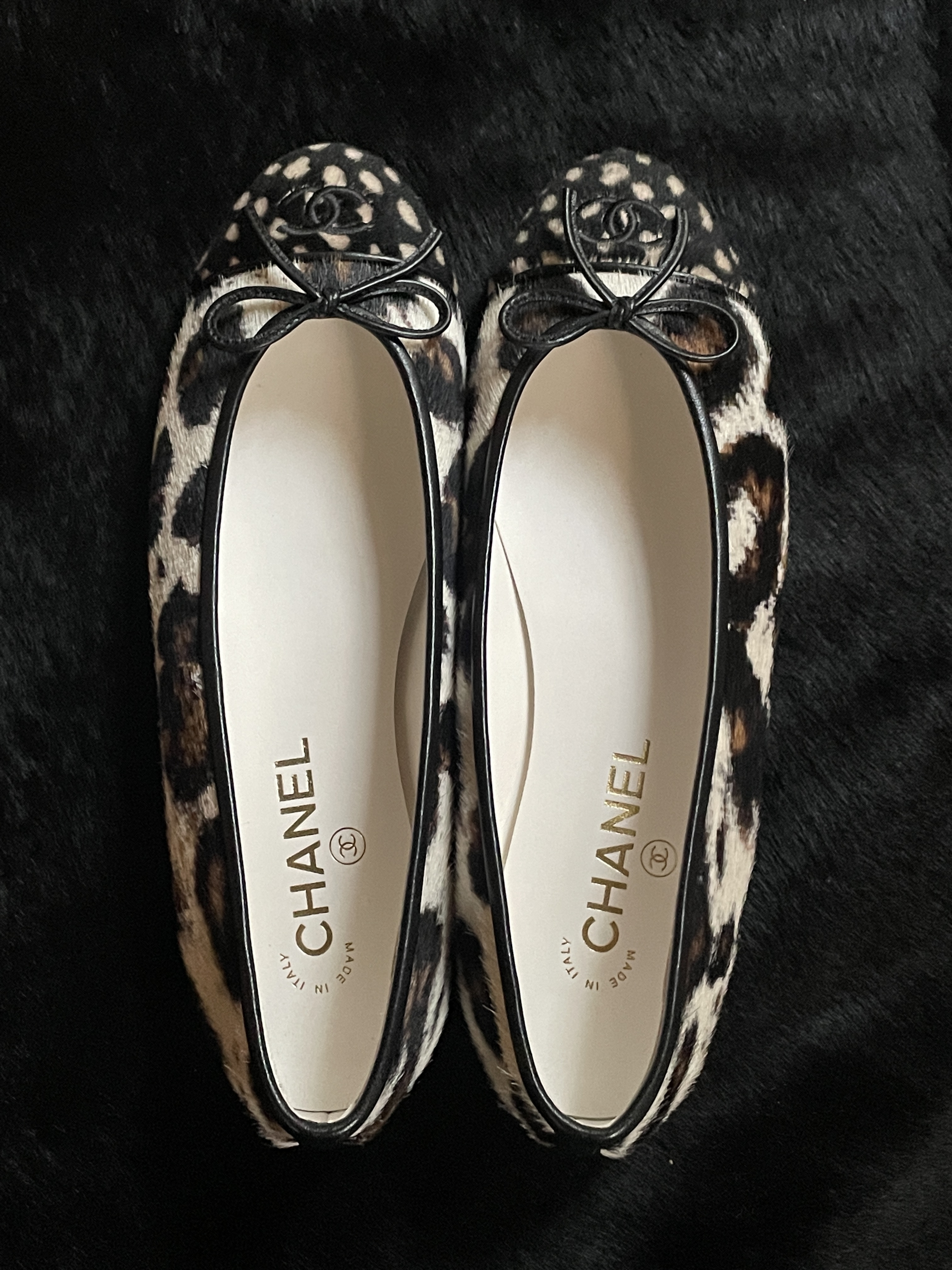 a close-up on the Chanel pony hair cap-toe ballet flats in leopard print and deepr print