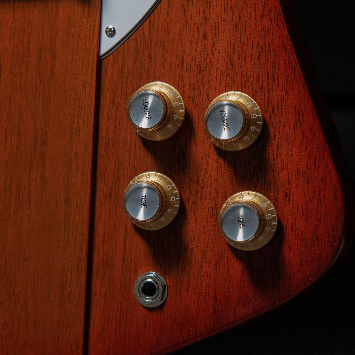 A photo showing a detail of the Gibson Firebird Platypus guitar in a recording studio setting