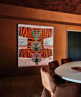 A dark orange dining room with a tiger print