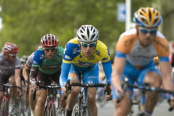 Jonathan Cantwell (green) of Fly V Australia keeps watch on Brad Wiggins and Chris Sutton both of Garmin-Slipstream in front.