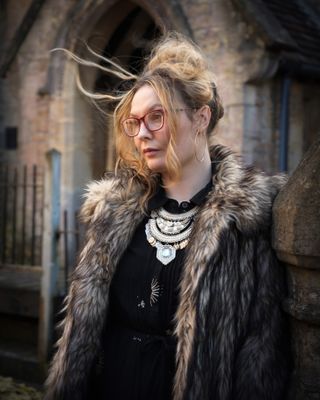 Hasselblad XCD 75P sample image of a woman wearing a fur coat standing in front of a church