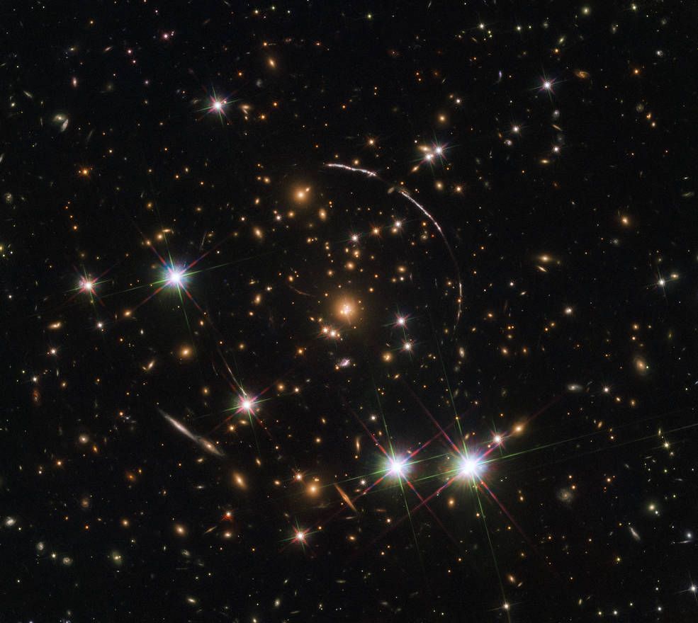 The Hubble Space Telescope recently captured 12 mirror images of the distant, gravitationally-lensed Sunburst Arc. The galaxy can be seen here in this &quot;kaleidoscope&quot; image distributed across four arcs (the elongated lines).