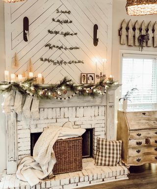 A white farmhouse inspired fireplace with foliage above mantel in tree shape