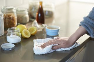 Hand cleaning counter with lemons and vinegar