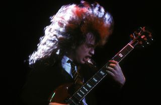Angus Young performs with AC/DC at Palais Omnisports of Paris Bercy on September 15, 1984 in Paris, France