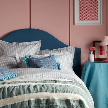 Secret Linen Store Molly Mahon Blue Bindi 100% Cotton Bed Linen on a bed in a pink bedroom